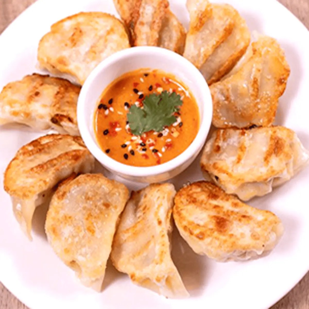 MoMo from Himalayan Spice Austin TX – steamed dumplings served with spicy sauce powered by Skiplyn.