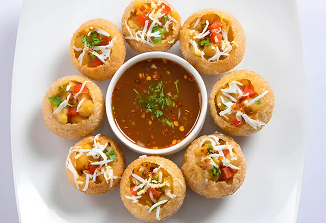 Pani Puri from Himalayan Spice Austin TX – crispy puris filled with spiced potatoes and tangy water powered by Skiplyn.